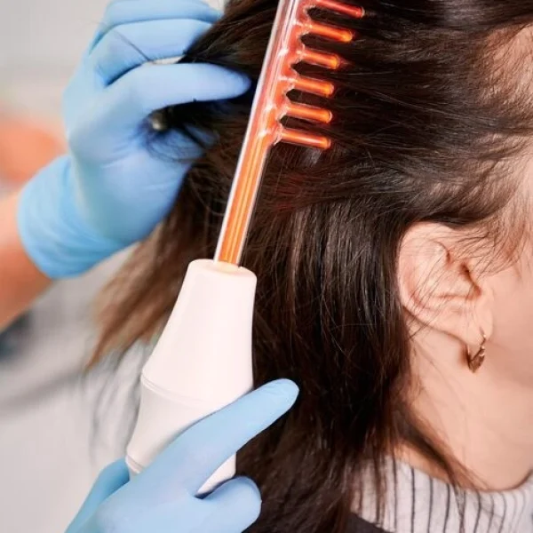 hair-specialist-brushing-woman-hair-with-laser-comb_651396-2524